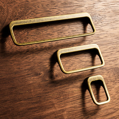Rounded rectangle cabinet pull, shown from one angle with related hardware in one display
