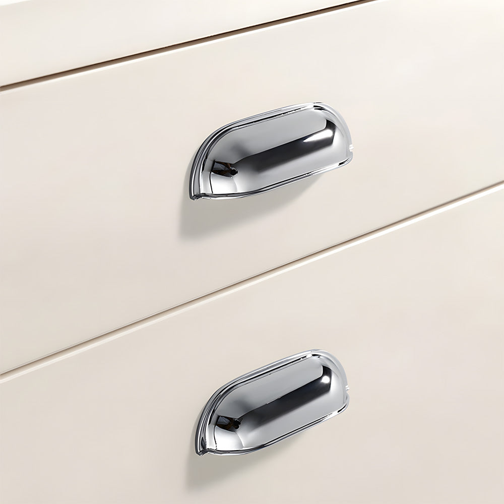Silver retro shell cup pull and round knob, shown at close range installed on cabinetry in context