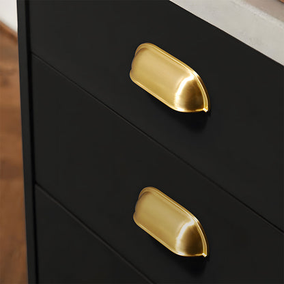 Brushed gold retro shell cup pull and round knob, shown clearly installed on cabinetry in context