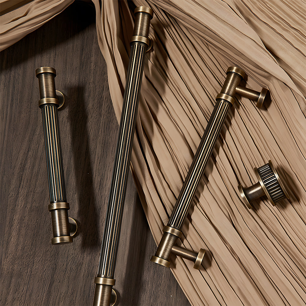 Ribbed bronze cabinet pull and round knob, displayed from the side with related hardware in one display