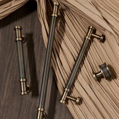 Ribbed bronze cabinet pull and round knob, displayed from the side with related hardware in one display