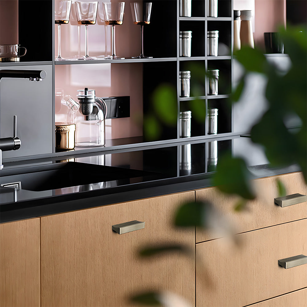 Antique bronze ribbed retro recessed cabinet pull, shown at close range installed on cabinetry in context