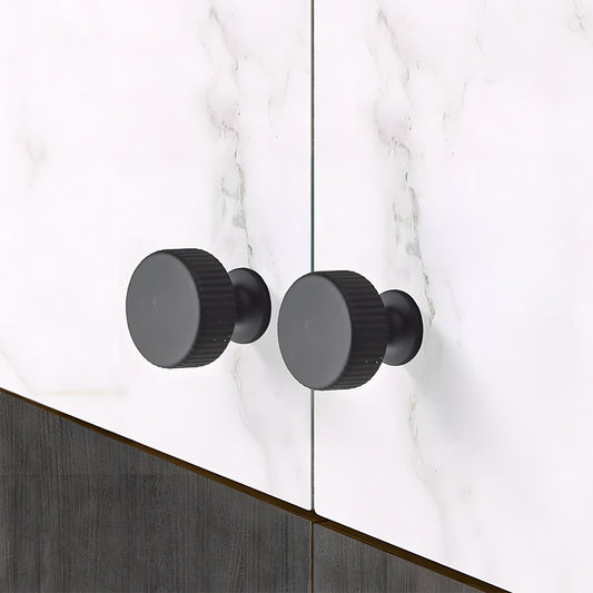 Black ribbed bar cabinet pull and round knob, presented for reference in an installed cabinet close-up