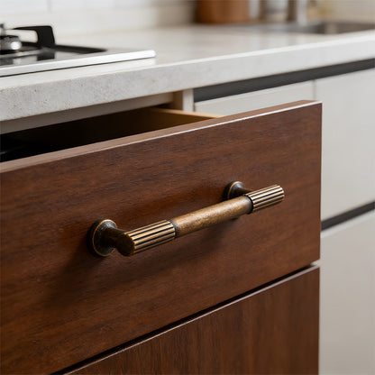 Antique bronze ribbed bar cabinet pull and round knob, displayed from the side in an installed cabinet close-up
