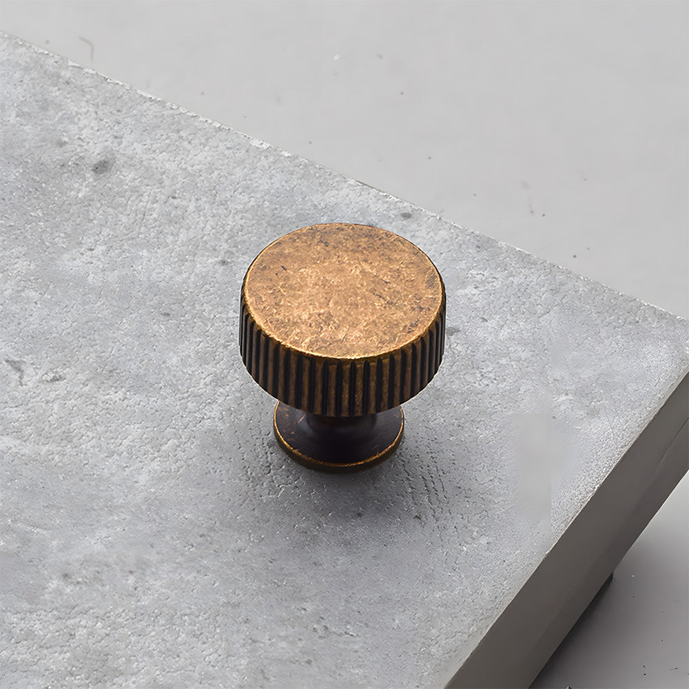 Antique bronze ribbed bar cabinet pull and round knob, presented for reference on a clean neutral background