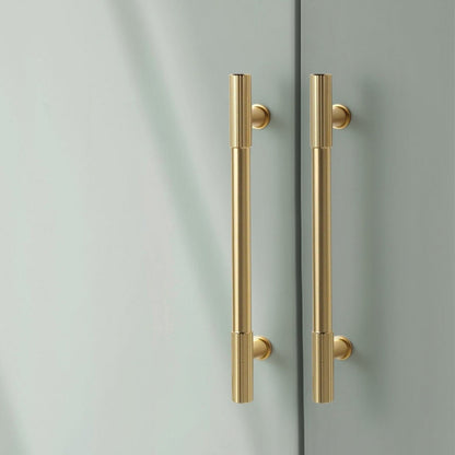 Gold ribbed bar cabinet pull and round knob, shown from one angle in an installed cabinet close-up