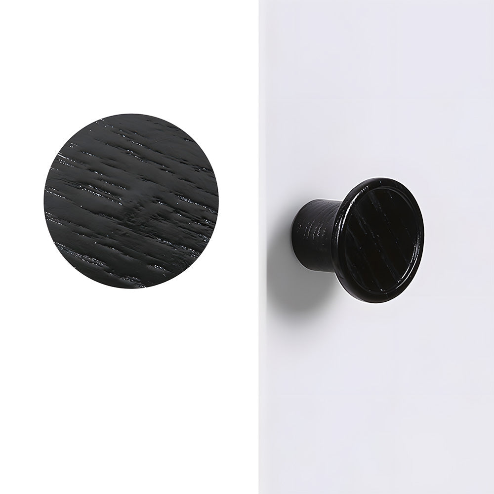 Round wood cabinet knob with a raised center profile, shown from a side angle on a light background