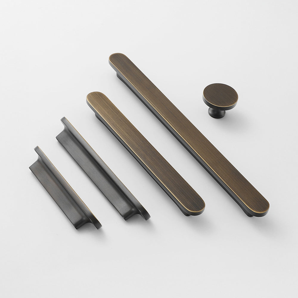 Bronze rounded-edge brass cabinet pull and round knob, shown at close range as a color and finish lineup