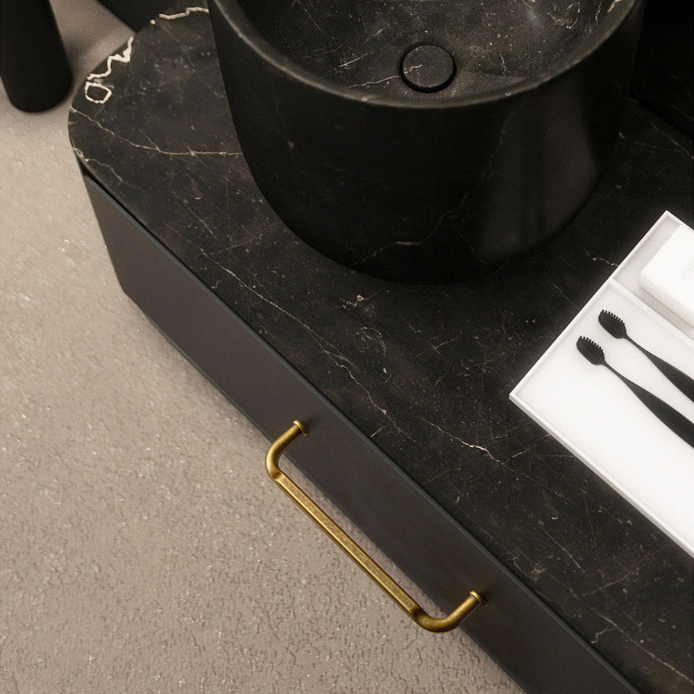 Smooth bronze cabinet pull with gently bent ends, pictured in one view installed on cabinetry in context