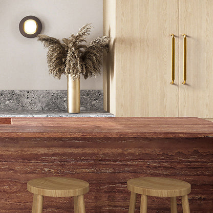 Smooth bronze cabinet pull with gently bent ends, shown at close range installed on cabinetry in context