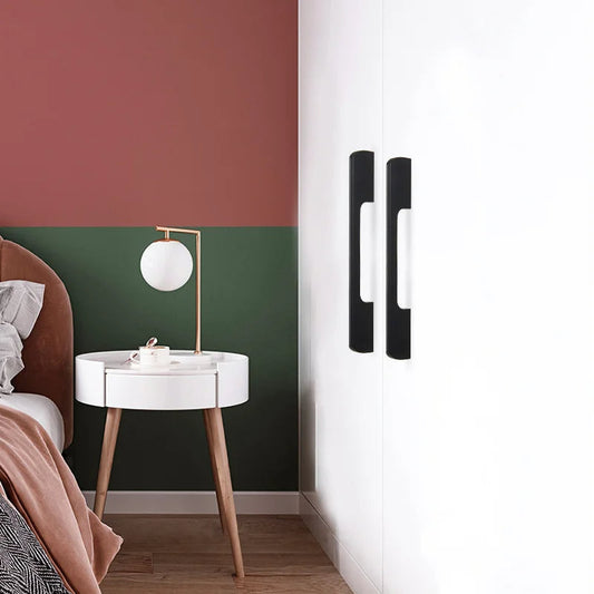 Matte black cabinet pulls with 96 mm hole centers installed vertically on white wardrobe doors