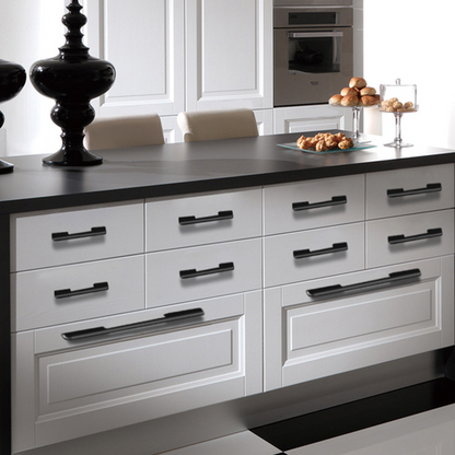 Matte black cabinet pulls with 128 mm hole centers installed on white kitchen drawers