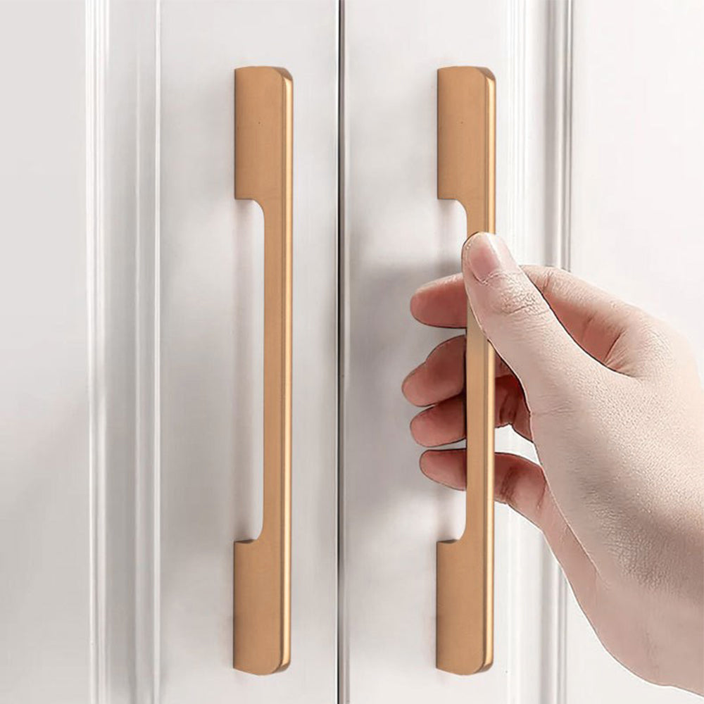 Champagne bronze cabinet pulls with 160 mm hole centers used vertically on white cabinet doors