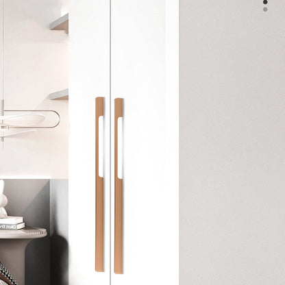 Extra-long champagne bronze cabinet pulls installed vertically on tall white wardrobe doors