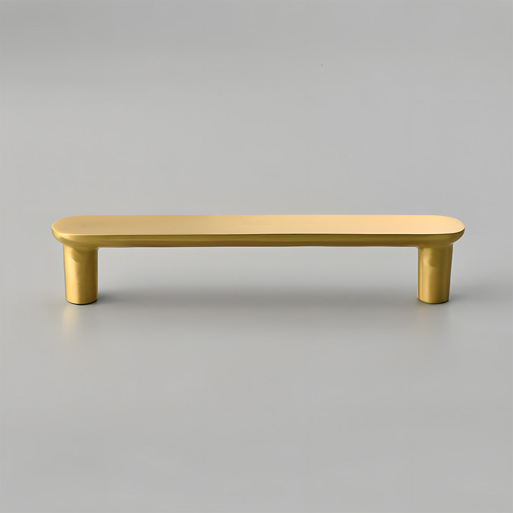 Gold brass rounded bar cabinet pull, displayed from the side on a clean neutral background