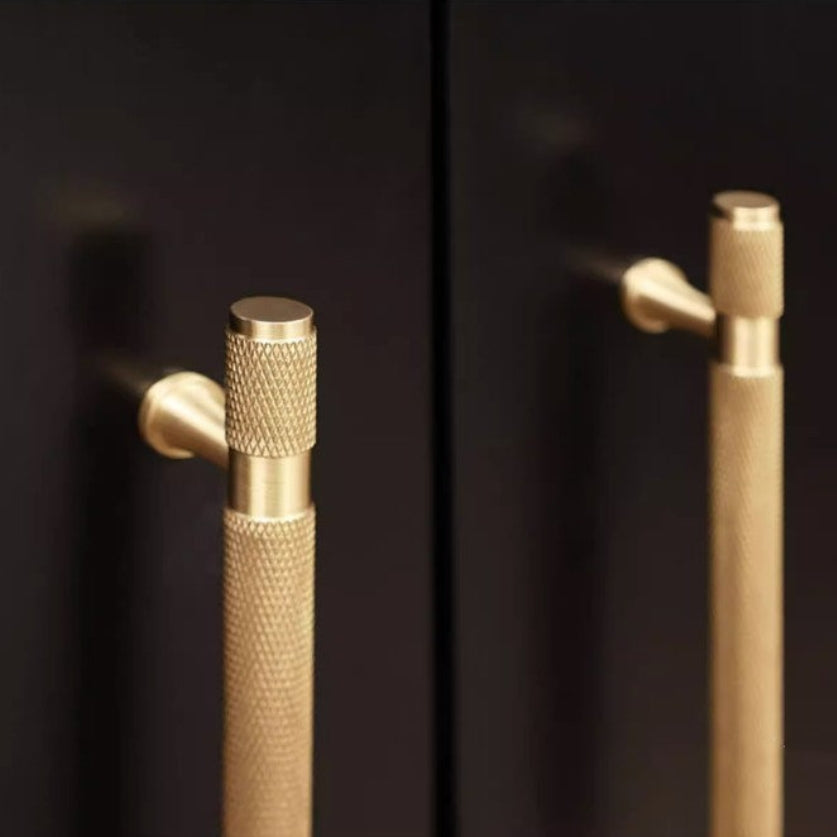 Knurled brass T-bar cabinet pull, shown from one angle with its construction and finish visible