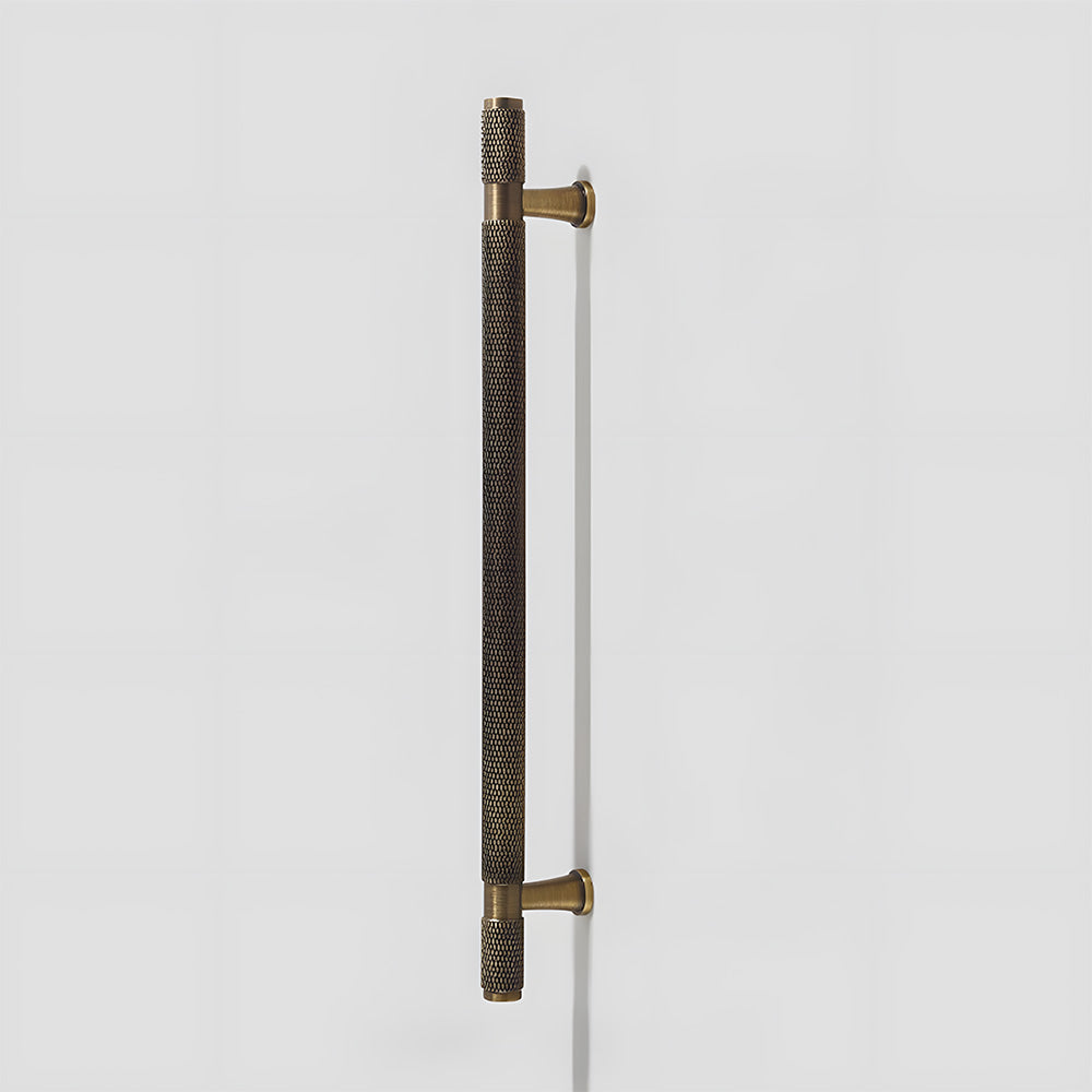 Knurled brass T-bar cabinet pull, presented for reference on a clean neutral background