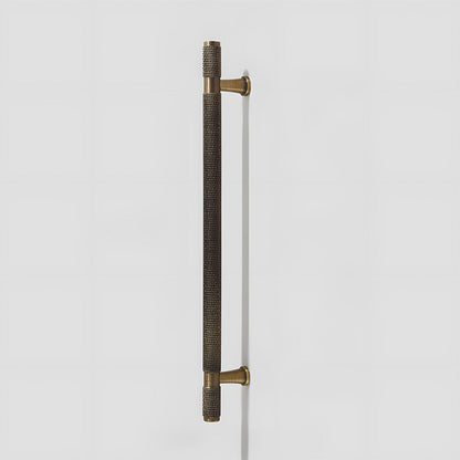 Knurled brass T-bar cabinet pull, presented for reference on a clean neutral background