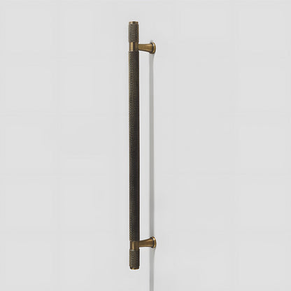 Knurled brass T-bar cabinet pull, shown at close range on a clean neutral background