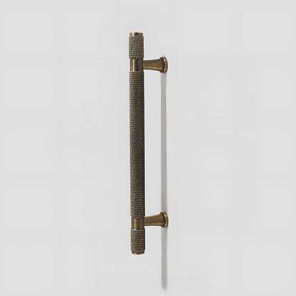 Antique bronze knurled brass T-bar cabinet pull, shown in a focused view on a clean neutral background