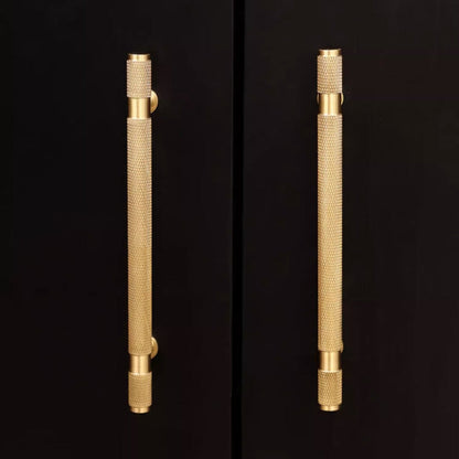 Gold knurled brass T-bar cabinet pull, presented for reference in an installed cabinet close-up