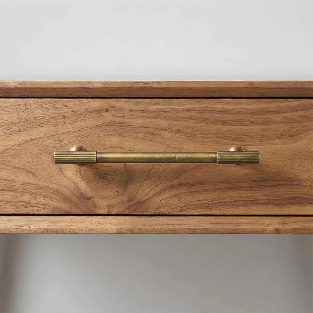 Bronze brass textured cabinet pull, pictured in one view in an installed cabinet close-up