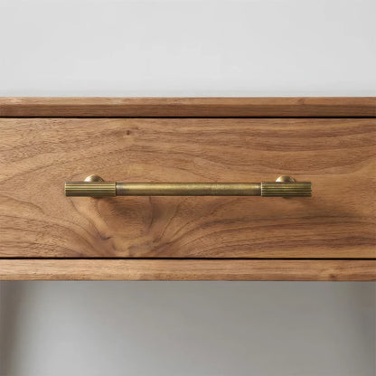 Bronze brass textured cabinet pull, pictured in one view in an installed cabinet close-up