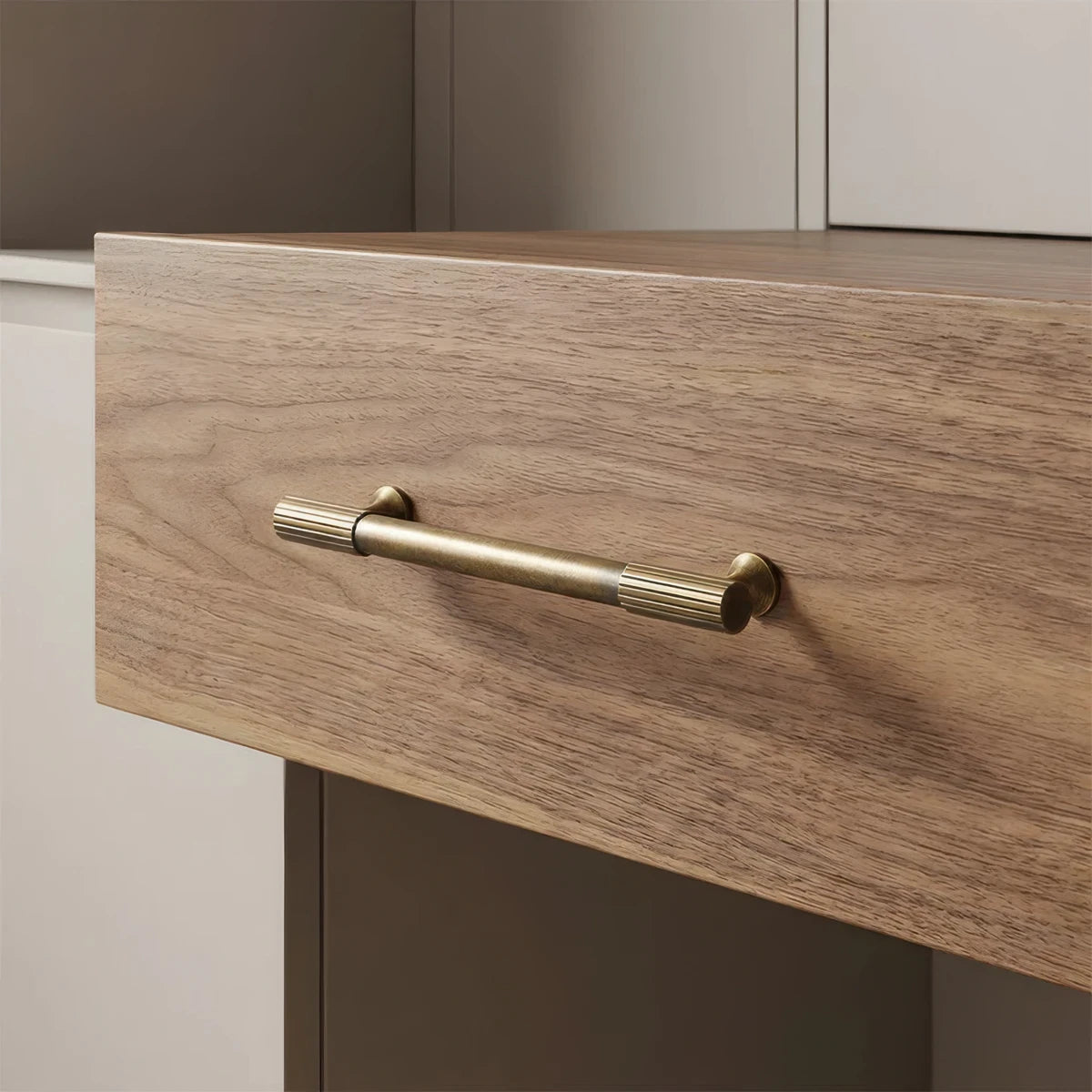 Brass textured cabinet pull, presented for reference in an installed cabinet close-up