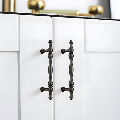 Black brass twisted cabinet pull and knobs, shown in a focused view installed on cabinetry in context