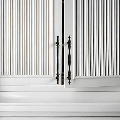 Black brass twisted cabinet pull and knobs, shown from one angle mounted on a finished cabinet front
