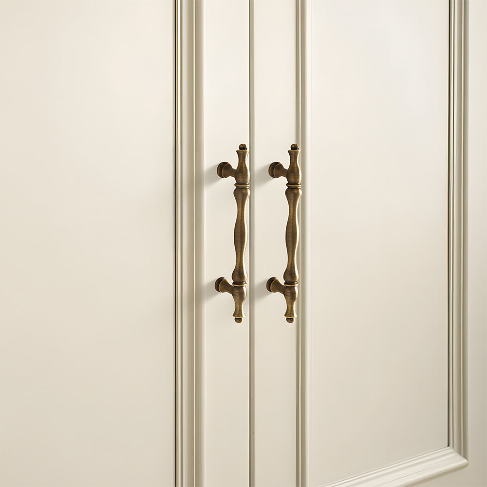Bronze brass twisted cabinet pull and knobs, shown at close range mounted on a finished cabinet front