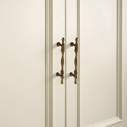 Bronze brass twisted cabinet pull and knobs, shown at close range mounted on a finished cabinet front
