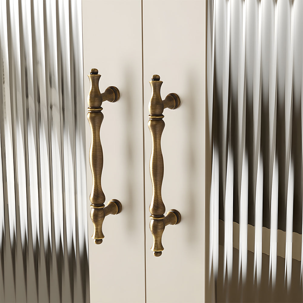 Bronze brass twisted cabinet pull and knobs, displayed from the side mounted on a finished cabinet front