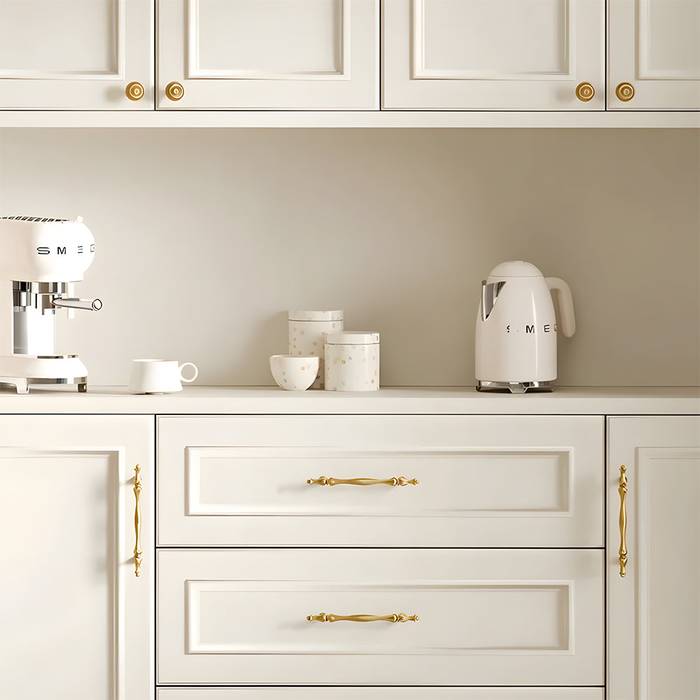 Gold brass twisted cabinet pull and knobs, shown clearly installed on cabinetry in context