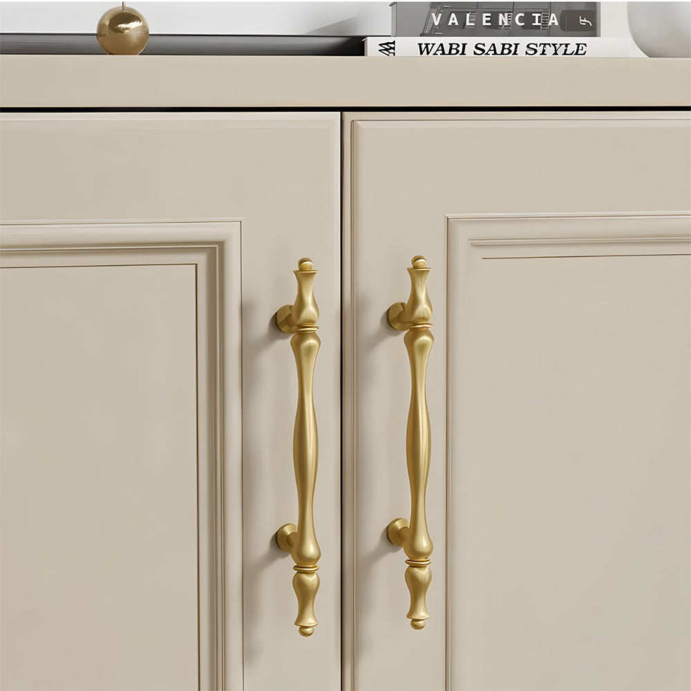 Gold brass twisted cabinet pull and knobs, shown from one angle installed on cabinetry in context