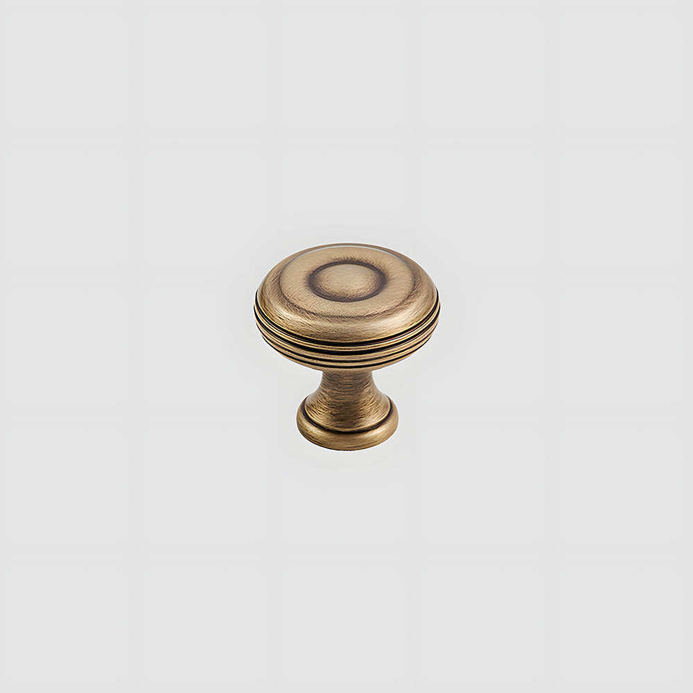 Bronze brass vintage cabinet pull and round knob, shown from one angle on a clean neutral background