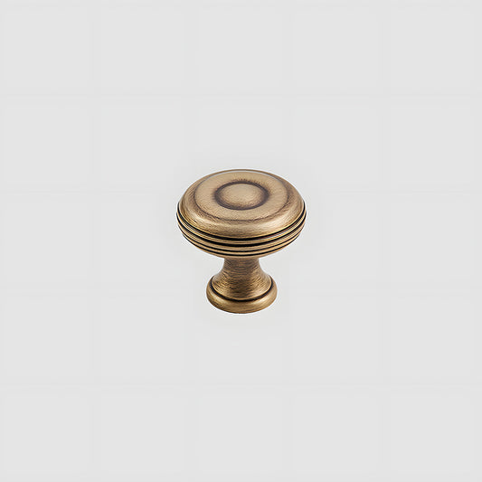 Bronze brass vintage cabinet pull and round knob, shown from one angle on a clean neutral background