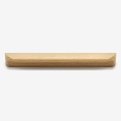 Solid beech wood half-round cabinet finger pull, shown from a close side angle against a plain surface