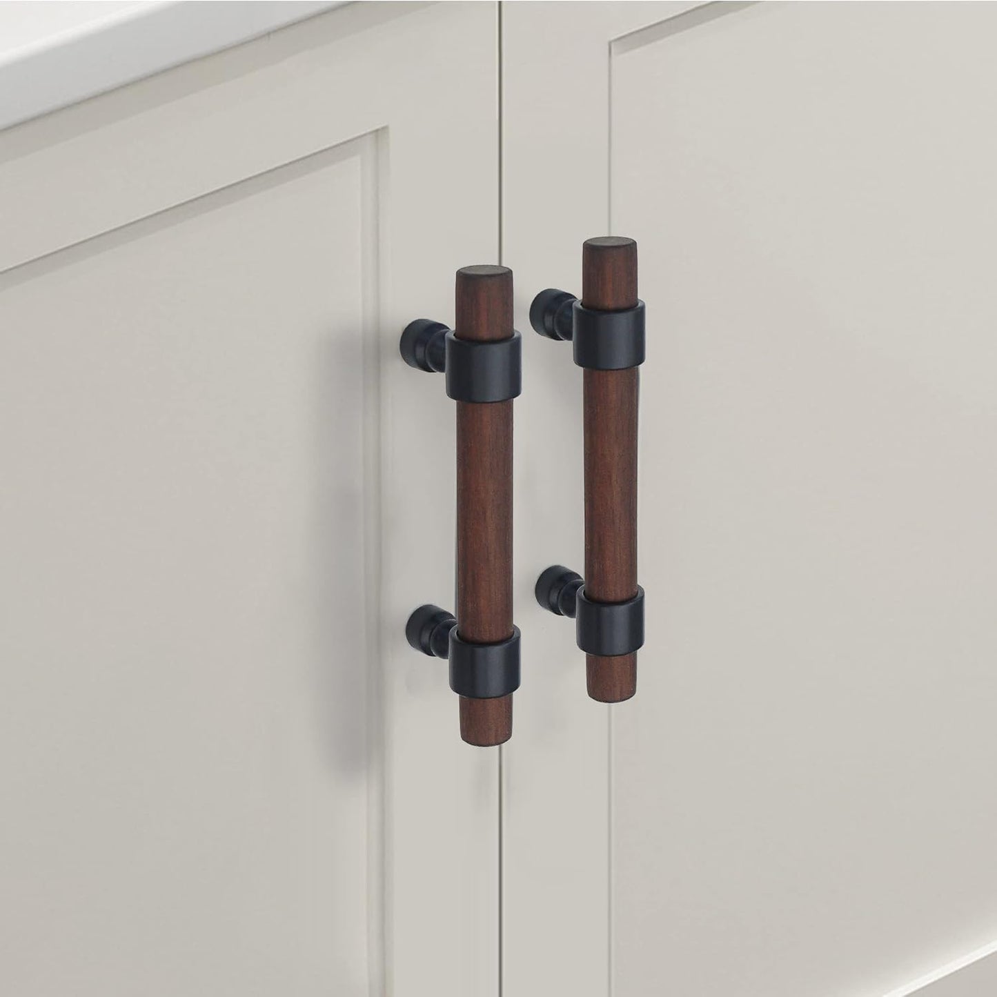 Wood cabinet pull with metal posts, mounted as matching hardware on double cabinet doors