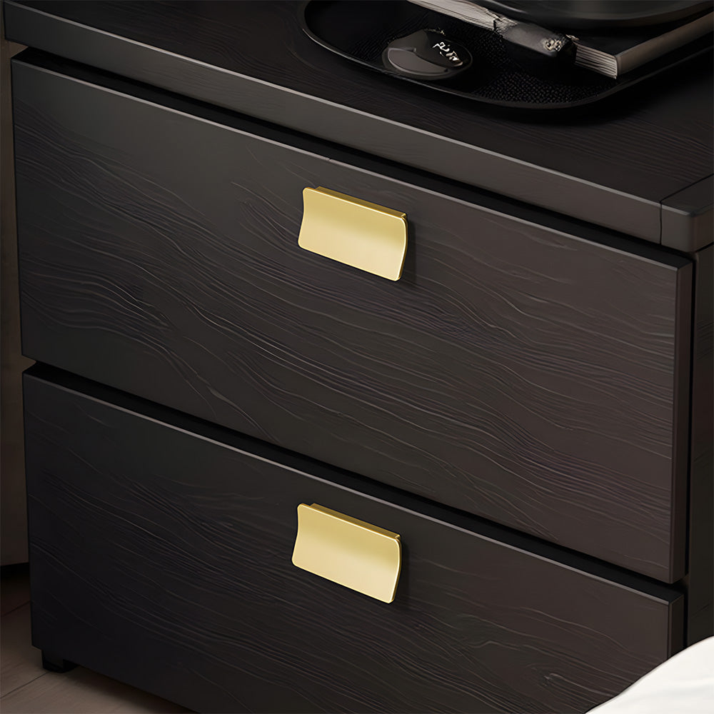 Gold square finger edge pull with a curved grip, shown from one angle installed on cabinetry in context
