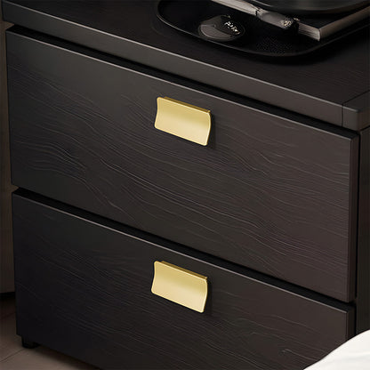 Gold square finger edge pull with a curved grip, shown from one angle installed on cabinetry in context