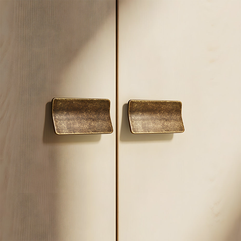 Square finger edge pull with a curved grip, pictured in one view installed on cabinetry in context