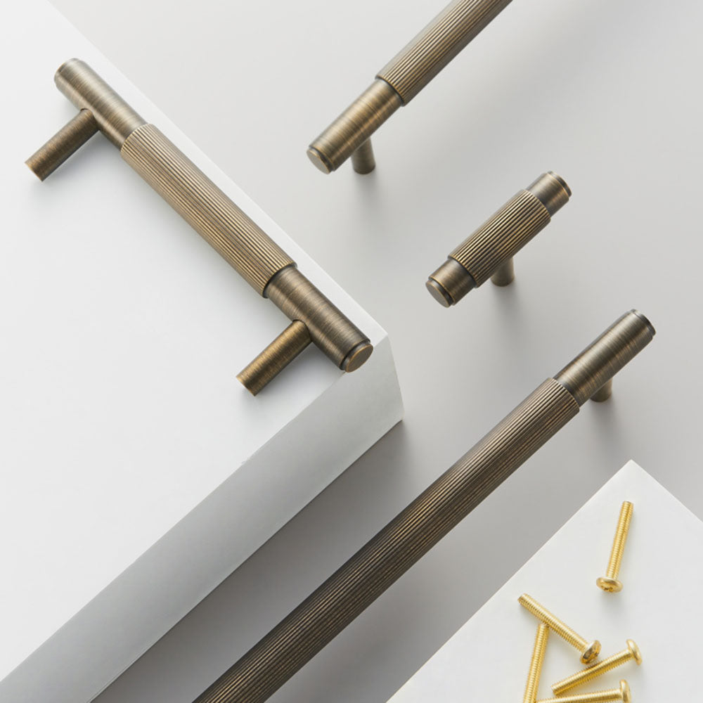 Striped T-bar cabinet pull, shown from one angle with related hardware in one display