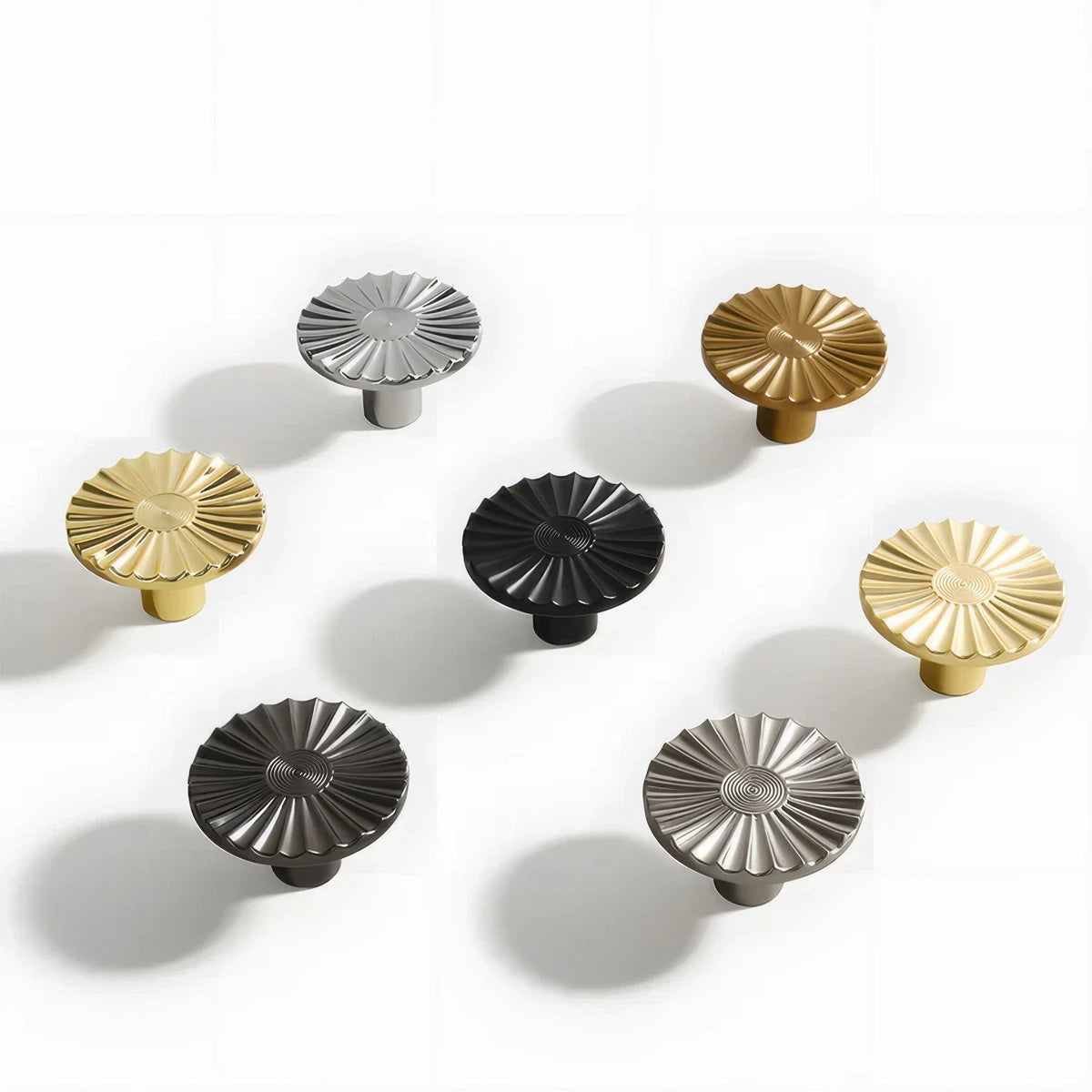 Sunburst half-moon cabinet pull and round knob, presented for reference as a color and finish lineup