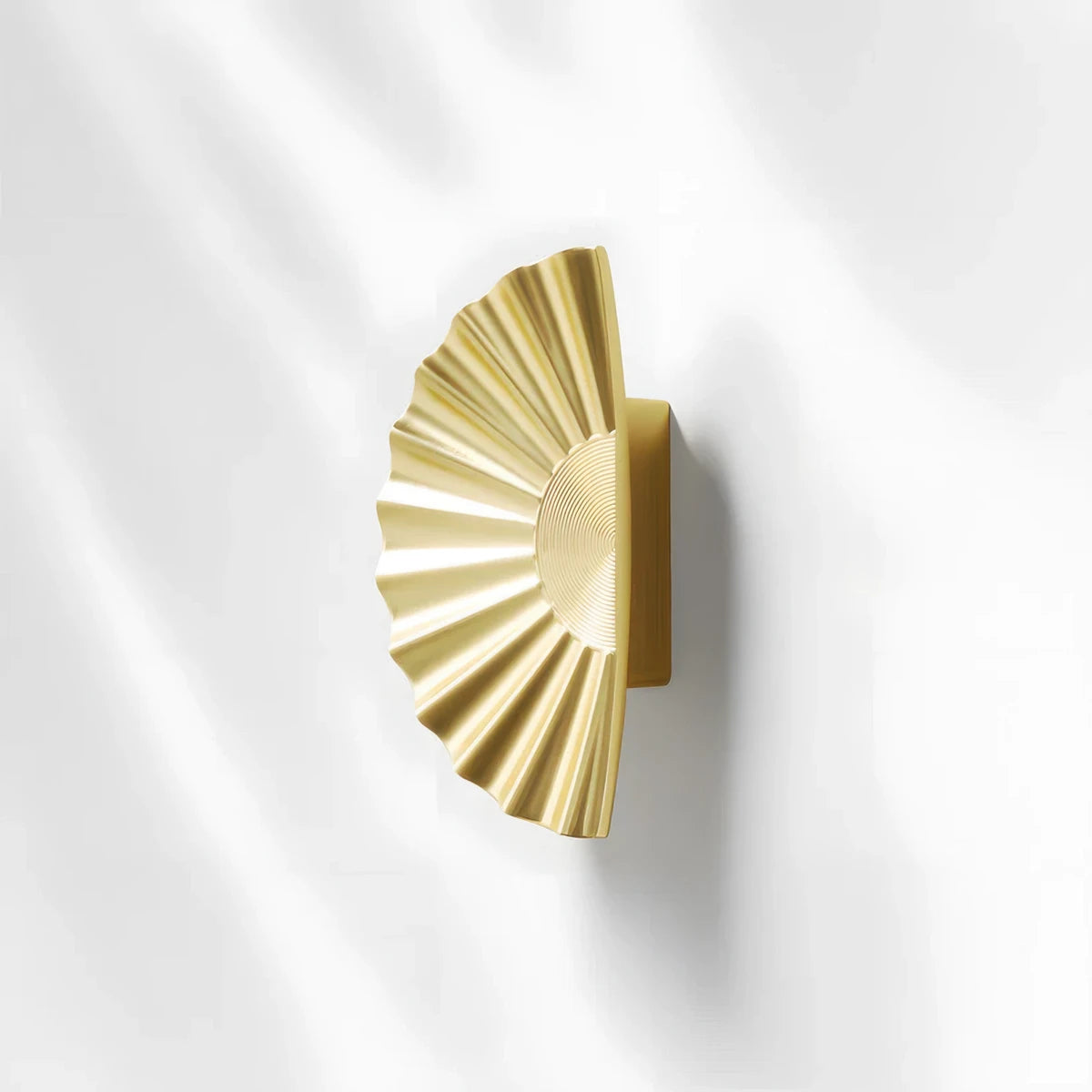 Sunburst half-moon cabinet pull and round knob, shown at close range on a clean neutral background