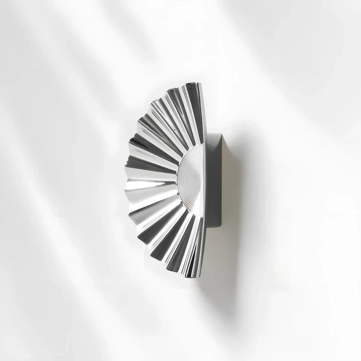 Silver sunburst half-moon cabinet pull and round knob, shown from one angle with its shape and finish visible