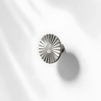 Sunburst half-moon cabinet pull and round knob, presented for reference with its shape and finish visible
