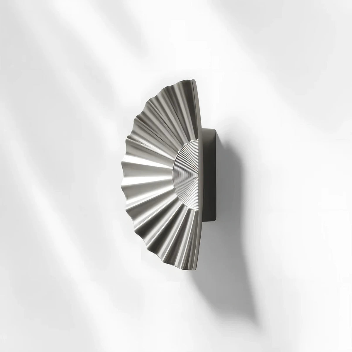 Sunburst half-moon cabinet pull and round knob, shown at close range with its shape and finish visible