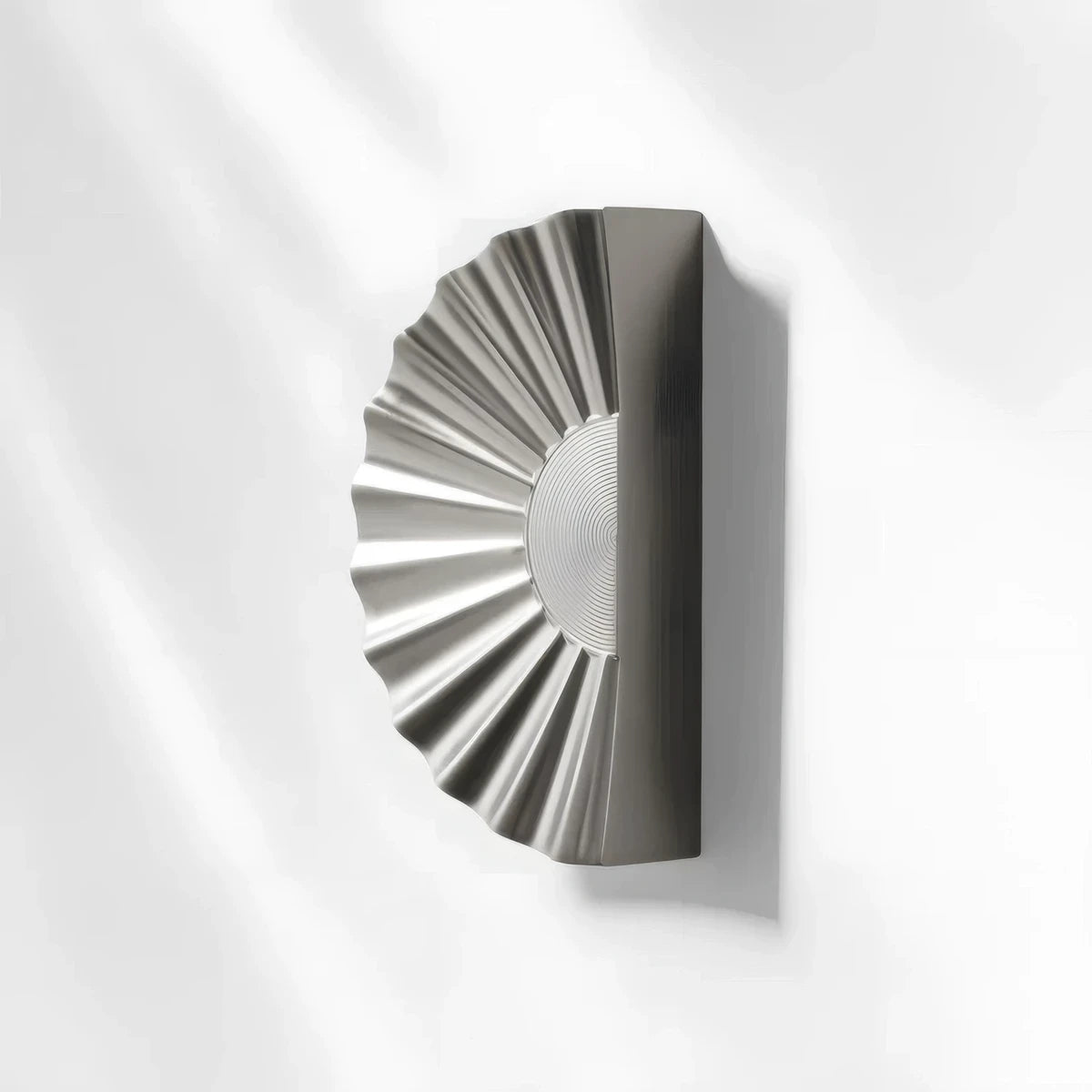 Sunburst half-moon cabinet pull and round knob, displayed from the side with its shape and finish visible