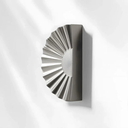 Sunburst half-moon cabinet pull and round knob, displayed from the side with its shape and finish visible